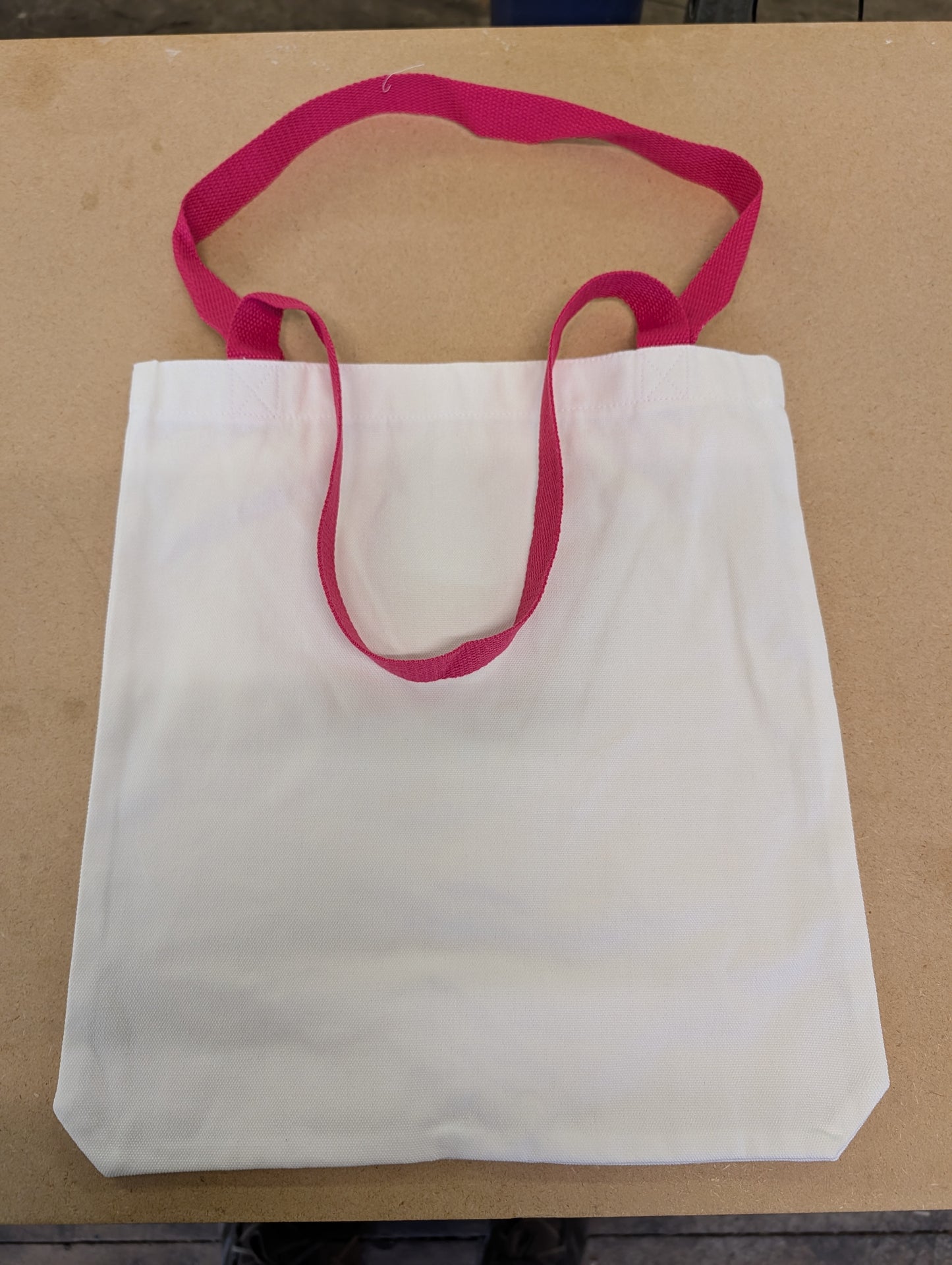 white canvas style tote bag with dark pink Handles