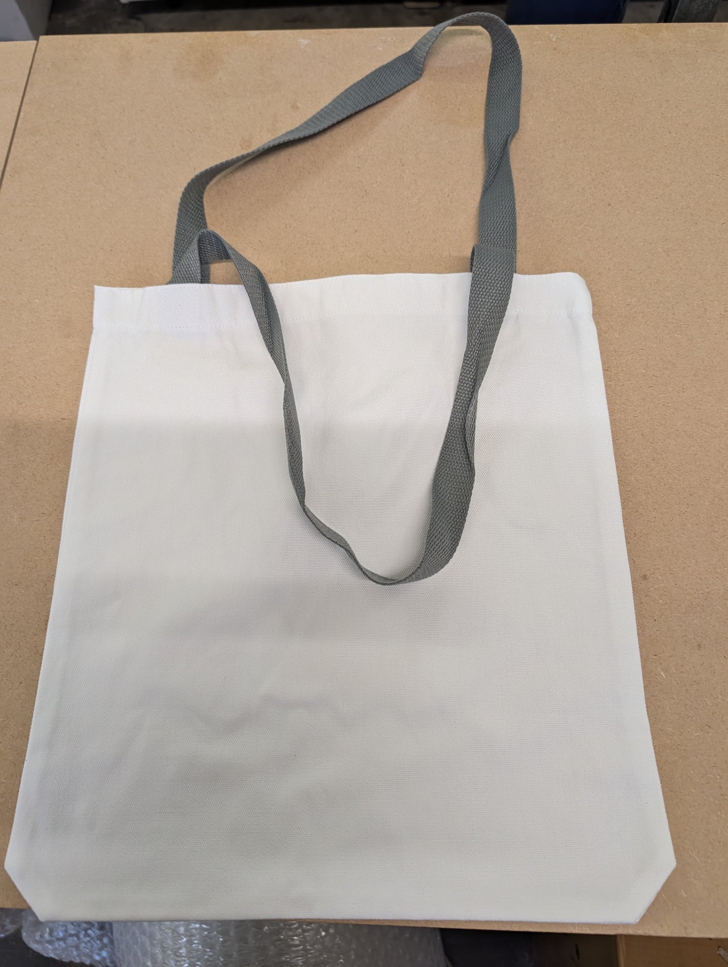 white canvas style tote bag with dark grey Handles